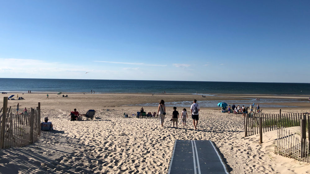Families enjoy a sunny afternoon at Cold Storage Beach in Dennis, Cape Cod.
