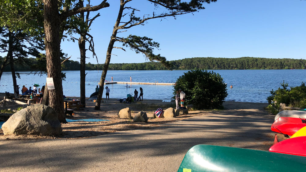 People relax on a sunny day at Gull Pond Landing Beach.