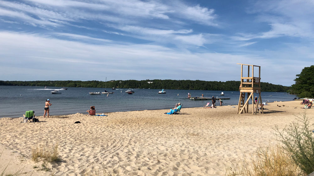 People relax along the shore at Long Pond in Harwich, Cape Cod.