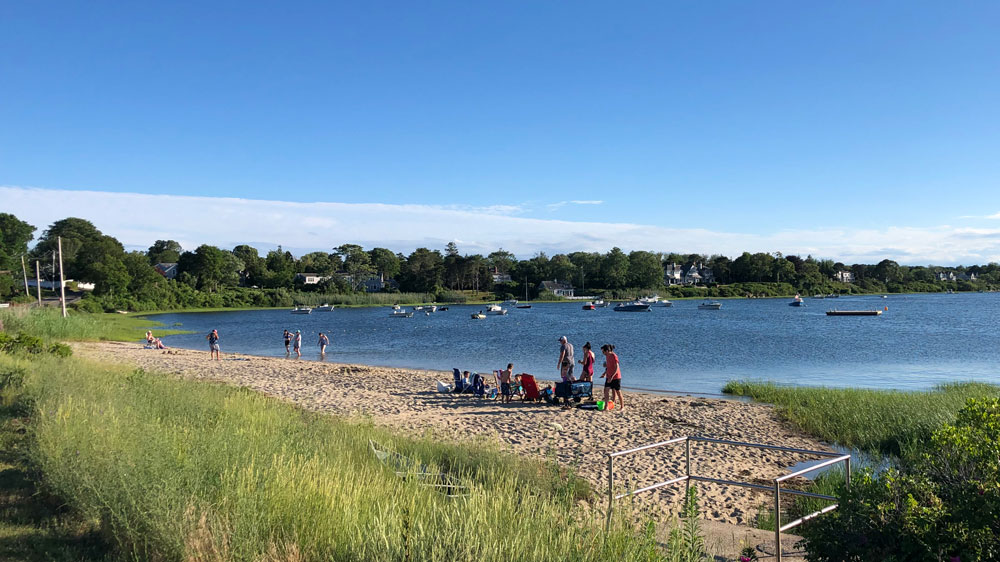 Families relax on the shore of Oyster Pond Beach in Chatham, Cape Cod.