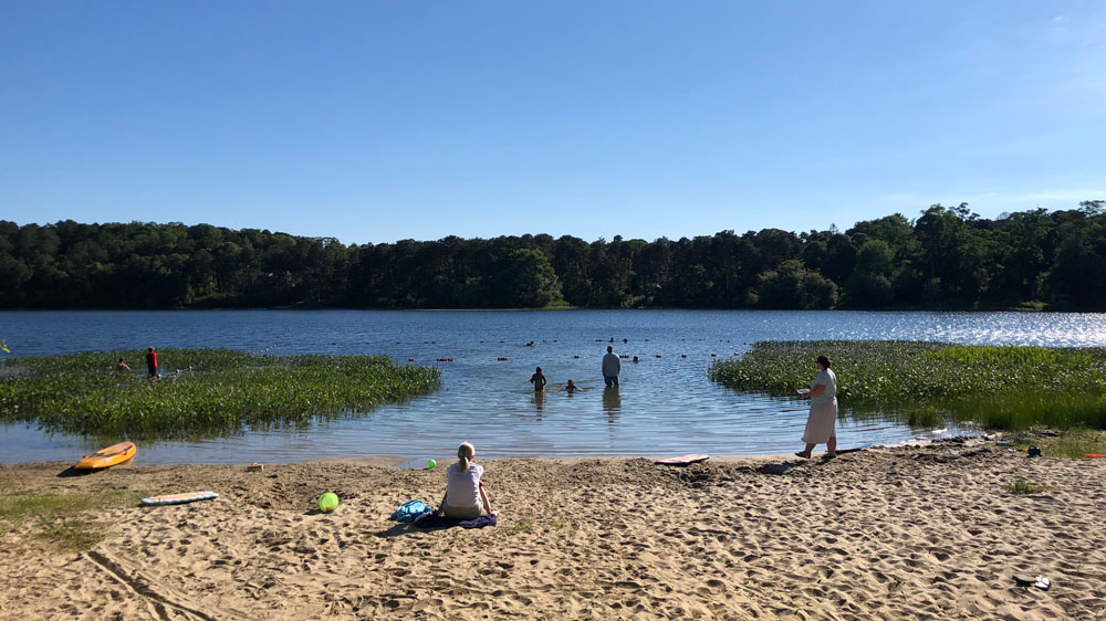 A family swims at Pilgrim Lake in Orleans, Cape Cod.