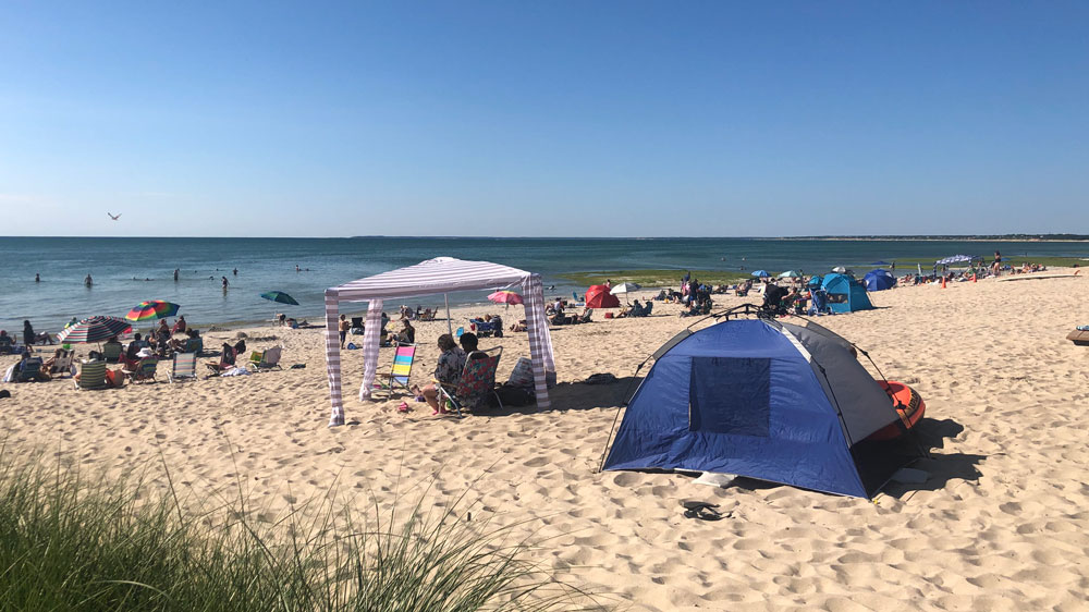 Beach tents and umbrellas line the shores of Skaket Beach in Orleans, Cape Cod.