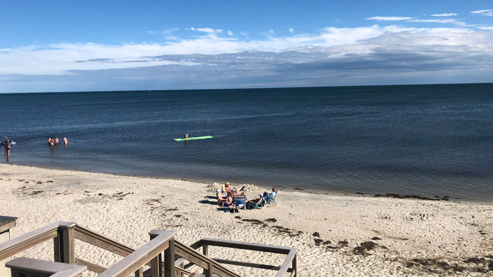 People relax along the shore at Zylpha Road Beach in Harwich, Cape Cod.