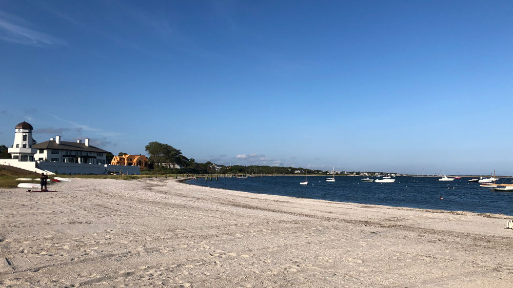 Boats sit offshore at Eugenia Fortes Beach in Barnstable, Cape Cod.