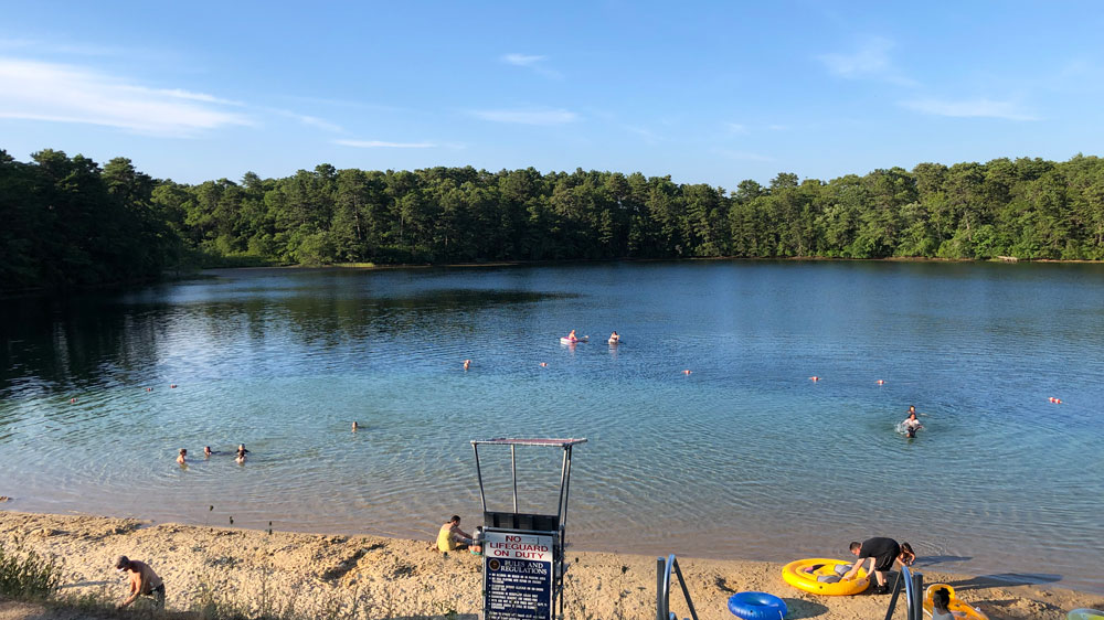 Swimmers enjoy a summer afternoon at Joshua's Pond in Barnstable, Cape Cod.