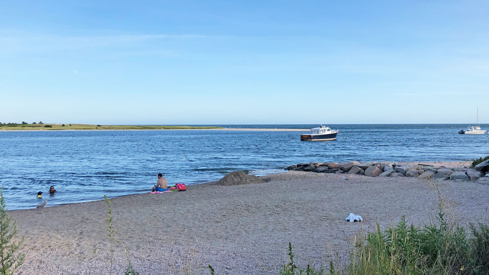 A boat sits just offshore at Rileys Beach in Barnstable, Cape Cod.