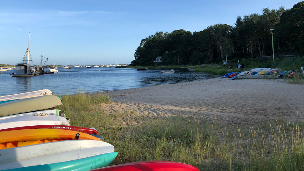 Kayaks line the shore at Rope's Beach in Barnstable, Cape Cod.