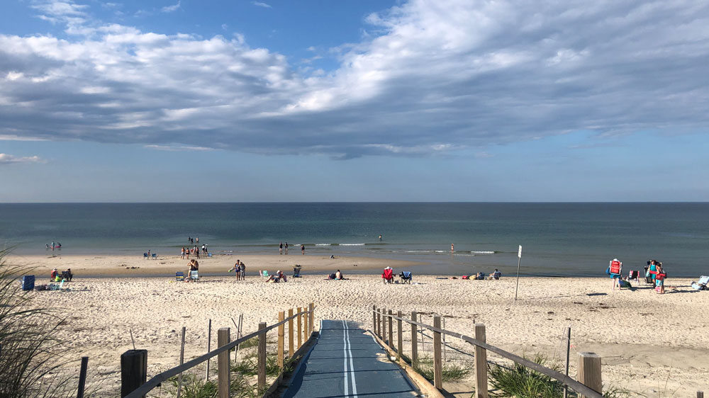 People explore the sand bars at Sandy Neck Beach in Barnstable, Cape Cod.