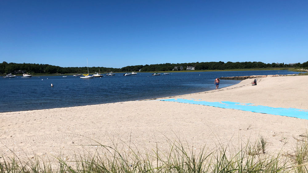 A swimmer exits the water at Barlows Landing in Bourne, Cape Cod.