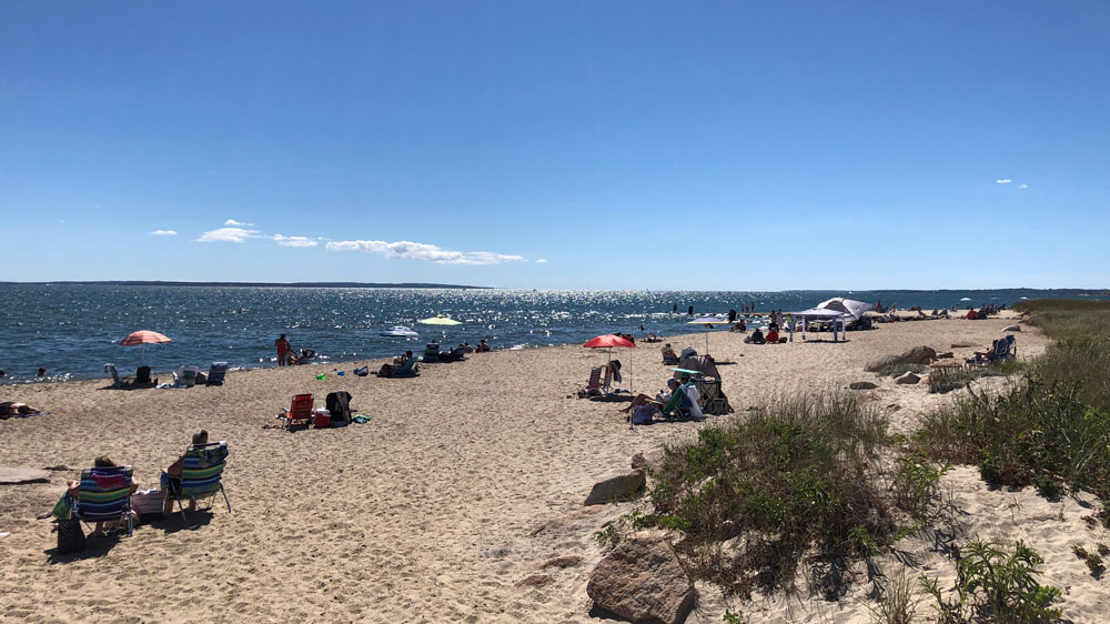 Umbrellas dot the shoreline of Menauhant Beach in Falmouth, Cape Cod.