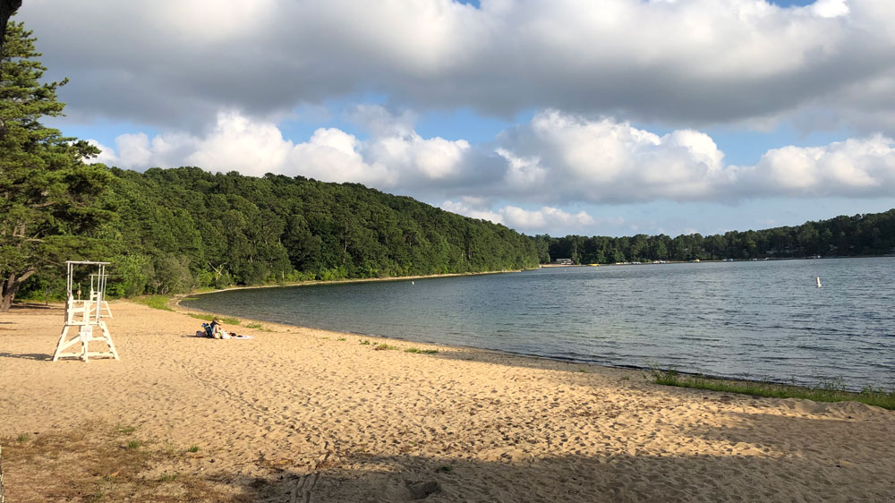 A couple enjoys a summer afternoon at Peters Pond at Oakcrest Cove in Sandwich, Cape Cod.