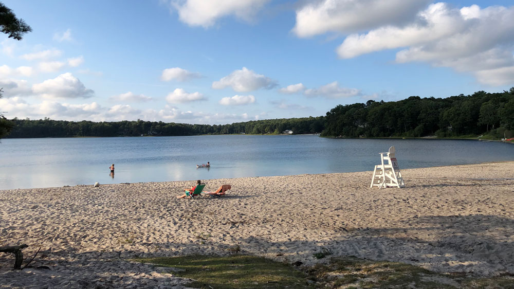 People relax on the shore of Snake Pond Beach in Sandwich, Cape Cod.