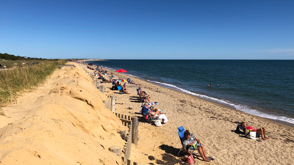 People relax on the shore of South Cape Beach in Mashpee, Cape Cod.
